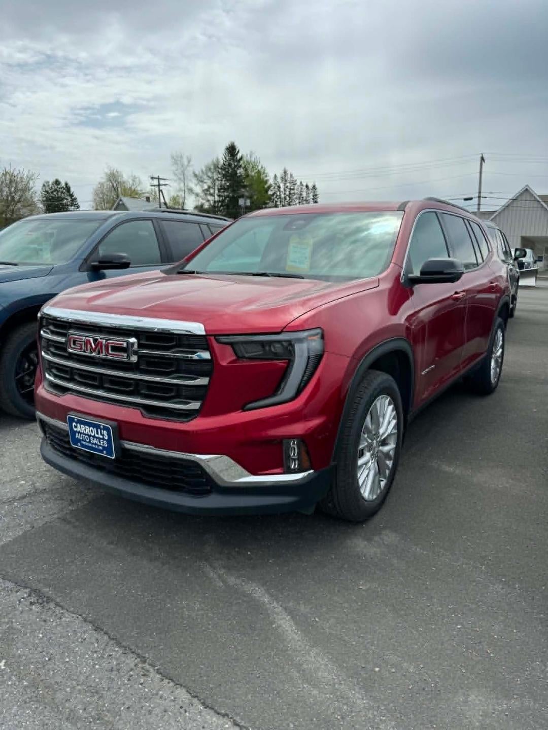 2026 GMC Acadia Elevation in Volcanic Red Tintcoat — front three-quarter view