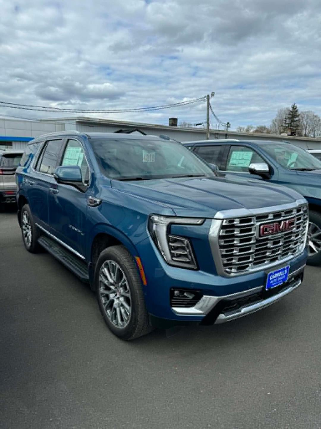 2026 GMC Yukon Denali in Downpour Metallic — front three-quarter view