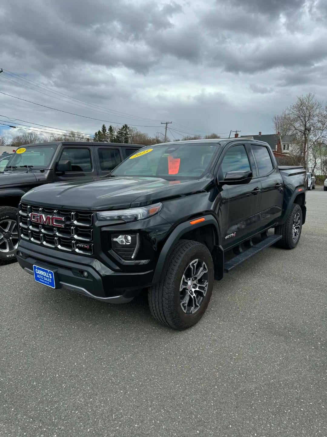 2025 GMC Canyon Crew Cab Short Box 4-Wheel Drive AT4 in Onyx Black — front three-quarter view